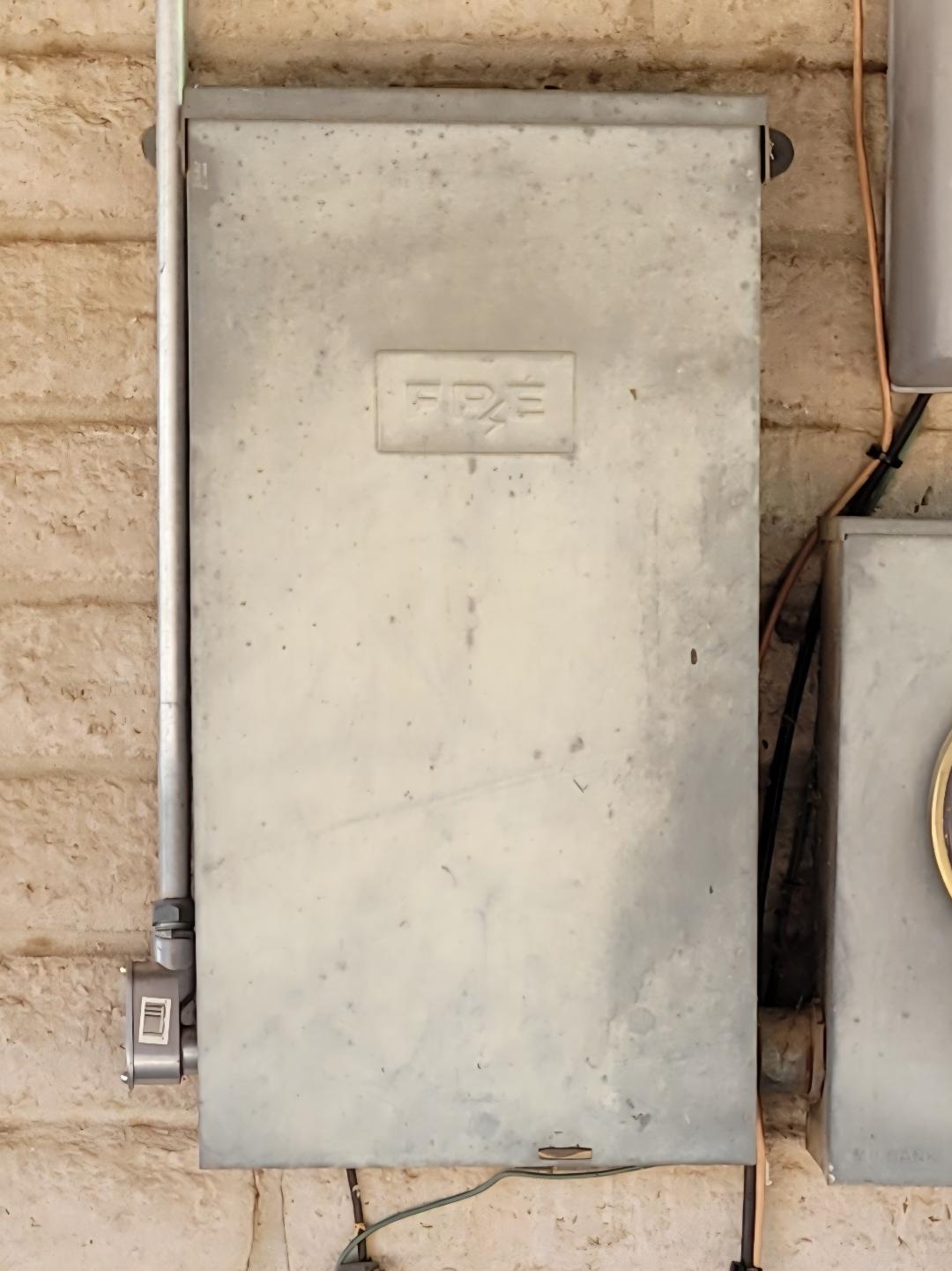 Federal Pacific Electric FPE panel cover with embossed FPE logo, indicating a Stab-Lok load center